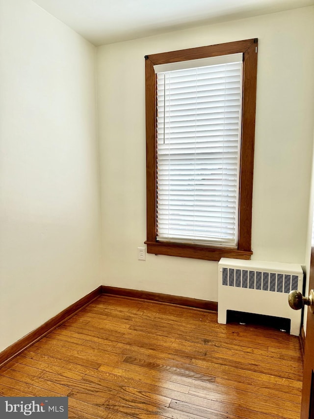 spare room with radiator and light hardwood / wood-style floors