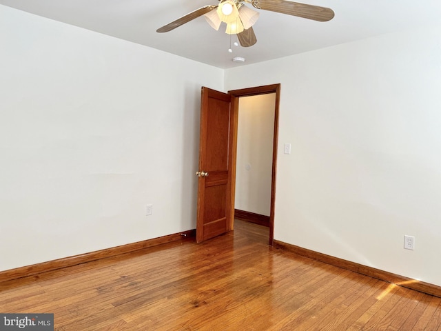 spare room with ceiling fan and hardwood / wood-style flooring