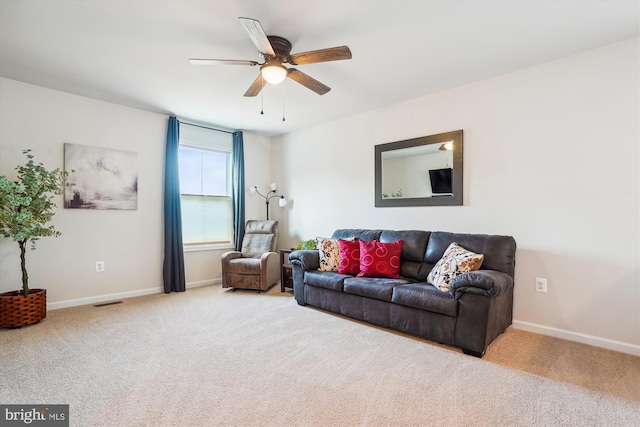 carpeted living area featuring ceiling fan, visible vents, and baseboards