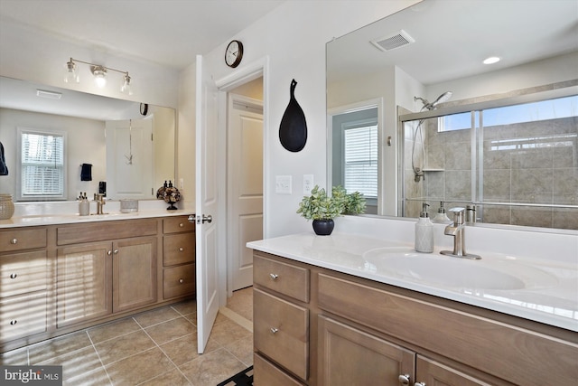 bathroom featuring two vanities, a sink, visible vents, and a shower stall