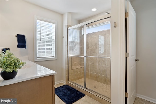 bathroom with baseboards, a stall shower, and tile patterned floors