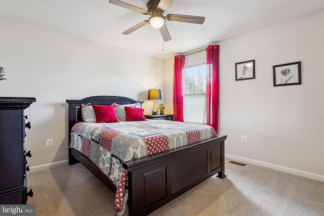 carpeted bedroom with visible vents, ceiling fan, and baseboards