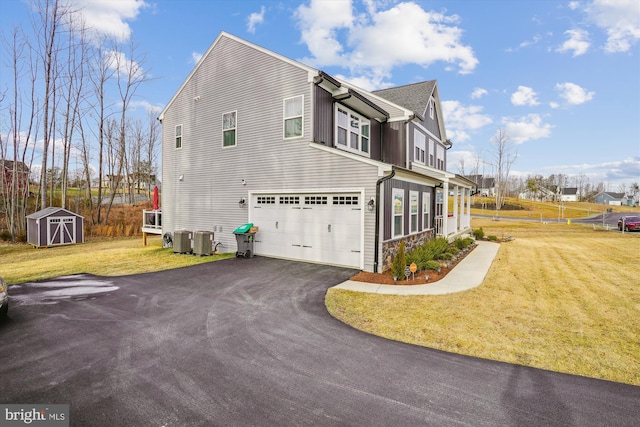 view of property exterior with cooling unit, driveway, a storage unit, and a lawn