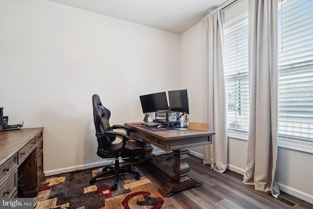 home office with baseboards and wood finished floors