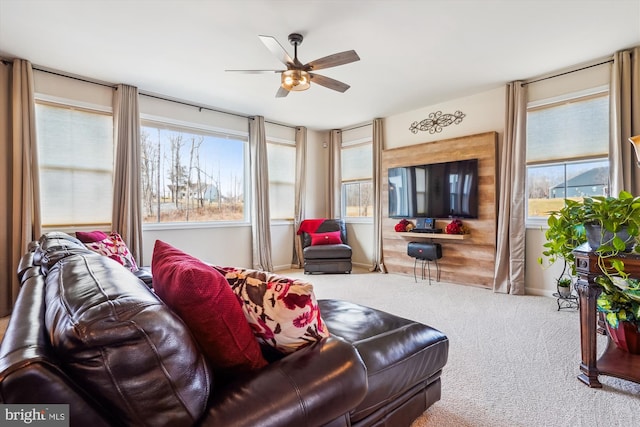 living area with ceiling fan and carpet floors