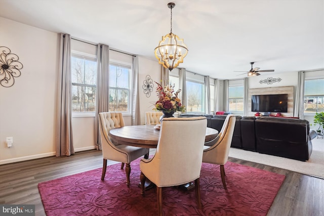 dining room featuring a healthy amount of sunlight, baseboards, and wood finished floors