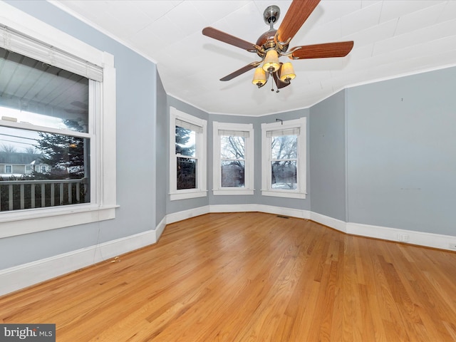 spare room featuring ceiling fan, ornamental molding, and light hardwood / wood-style floors