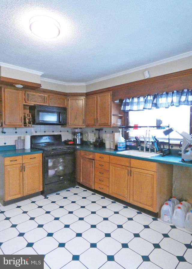 kitchen with a textured ceiling, black appliances, decorative backsplash, sink, and crown molding