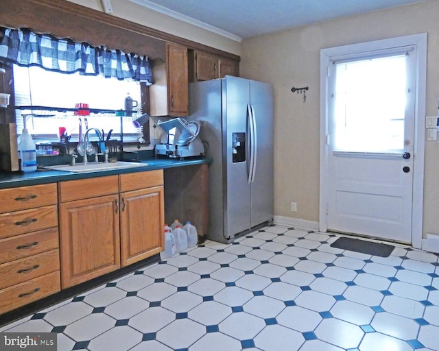 kitchen featuring sink, a wealth of natural light, and stainless steel fridge