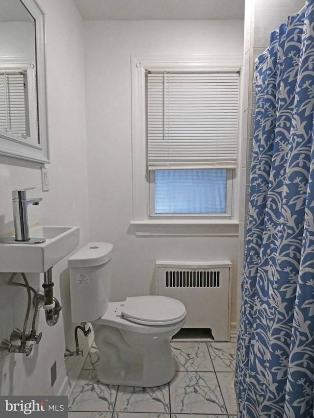 bathroom featuring sink, toilet, radiator heating unit, and a shower with shower curtain