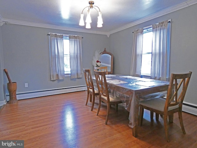 dining room with a baseboard heating unit, crown molding, a notable chandelier, and a healthy amount of sunlight