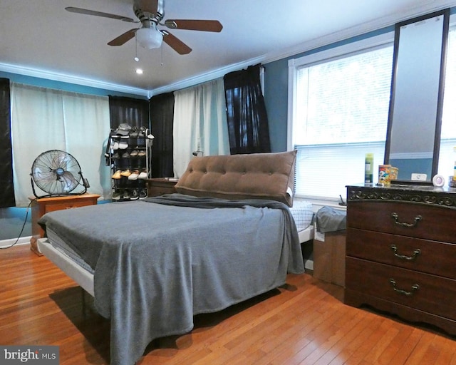 bedroom featuring light wood-type flooring, ceiling fan, and crown molding