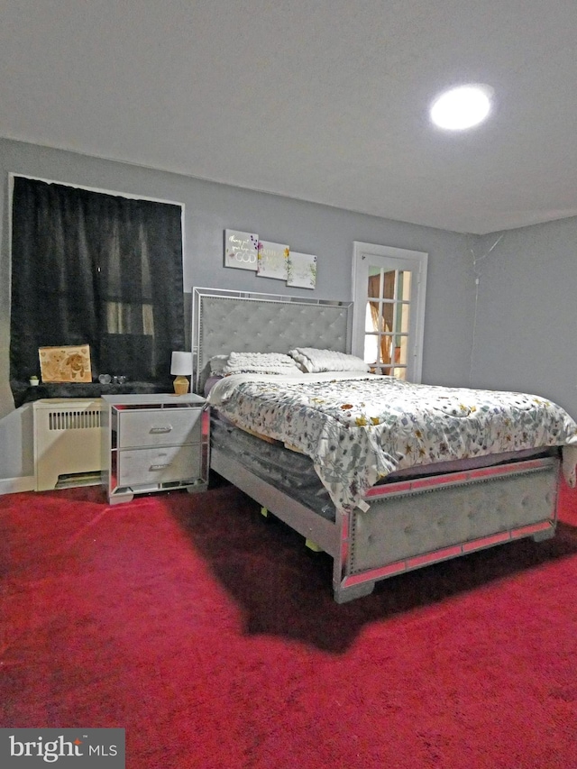 bedroom with carpet floors and radiator heating unit