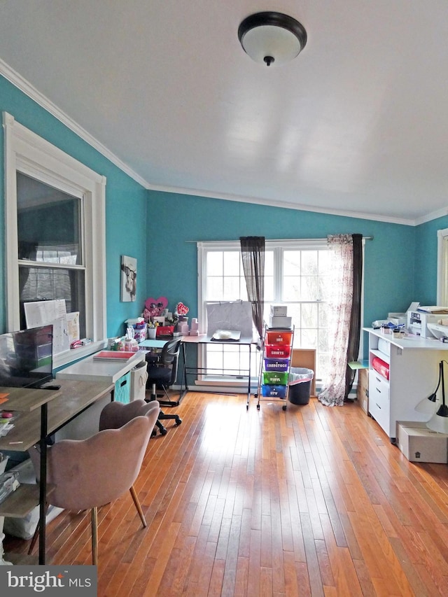 office area with light wood-type flooring and ornamental molding