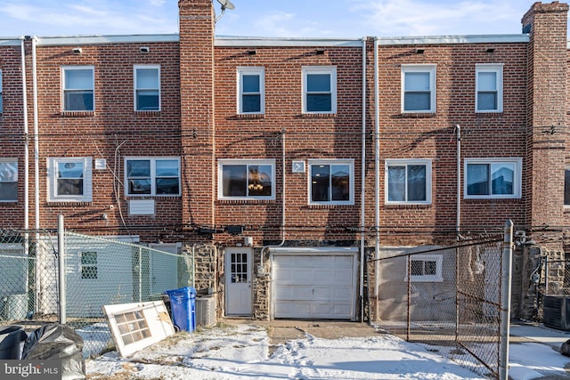 view of snow covered rear of property