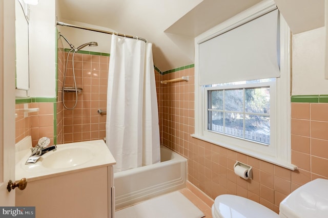 full bathroom featuring toilet, vanity, tile walls, and shower / bath combination with curtain