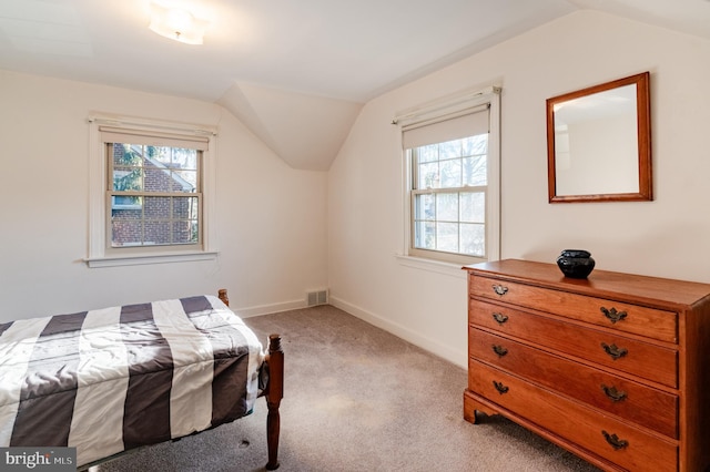 bedroom with light carpet and lofted ceiling