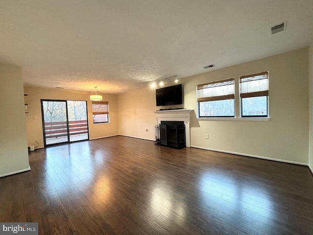 unfurnished living room featuring dark wood-type flooring