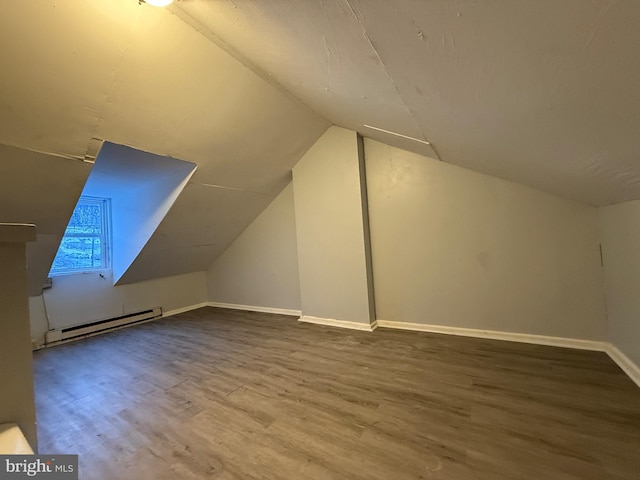 bonus room with wood-type flooring, lofted ceiling, and a baseboard radiator