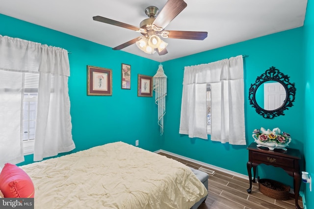 bedroom featuring ceiling fan and multiple windows