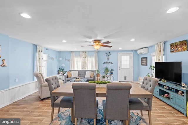 dining space featuring ceiling fan and an AC wall unit