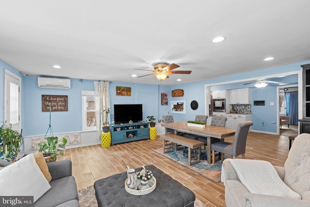 living room with ceiling fan and a wall unit AC