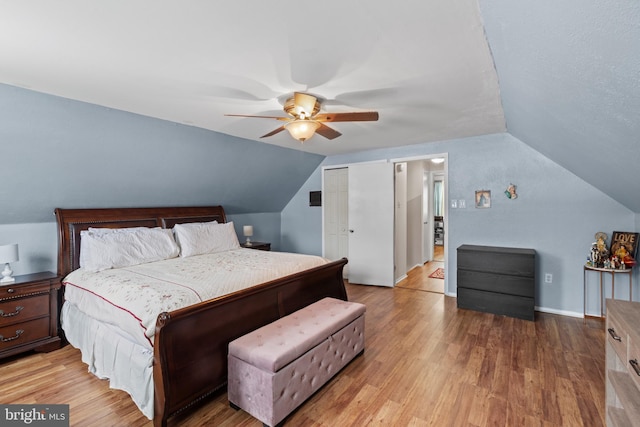 bedroom featuring vaulted ceiling, ceiling fan, and light hardwood / wood-style flooring