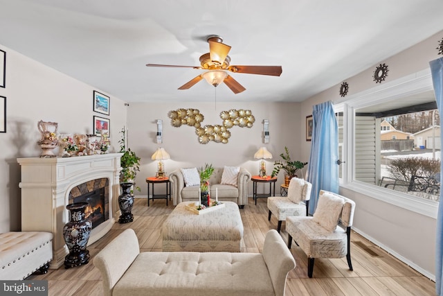 living room with ceiling fan and light hardwood / wood-style floors