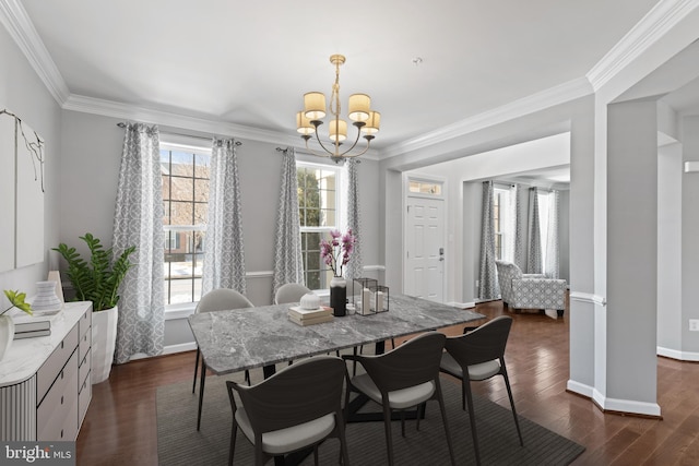 dining room with crown molding, dark wood-type flooring, and a chandelier