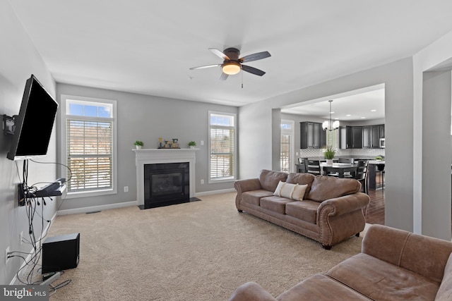 living room with ceiling fan and light colored carpet