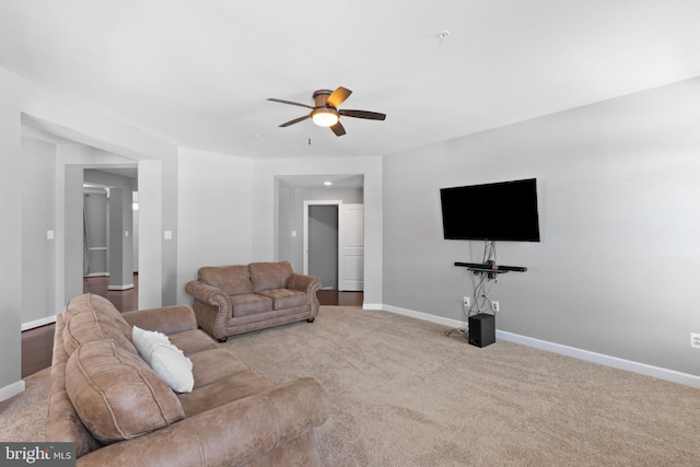 carpeted living room with ceiling fan