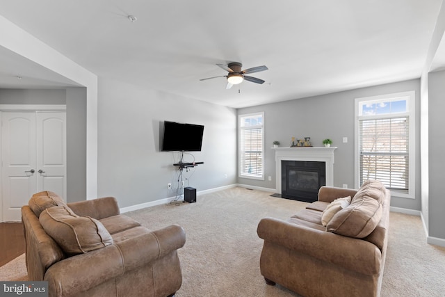 living room with ceiling fan and light colored carpet