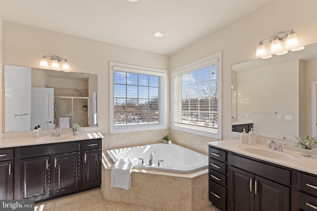 bathroom featuring tile patterned floors, vanity, and separate shower and tub