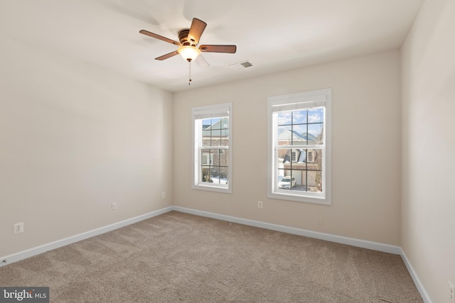 spare room featuring ceiling fan and carpet flooring