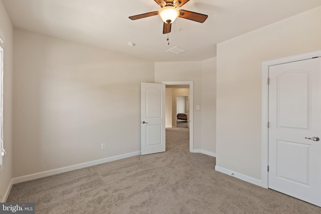 unfurnished bedroom featuring ceiling fan and light carpet