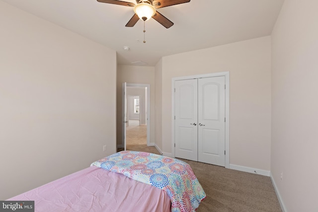 bedroom with a closet, ceiling fan, and light carpet