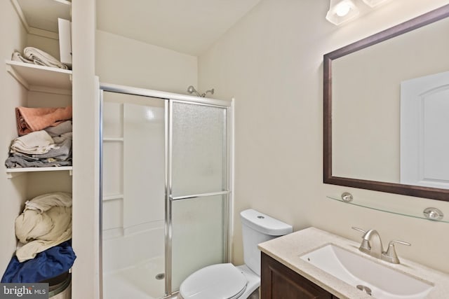 bathroom with vanity, toilet, and walk in shower