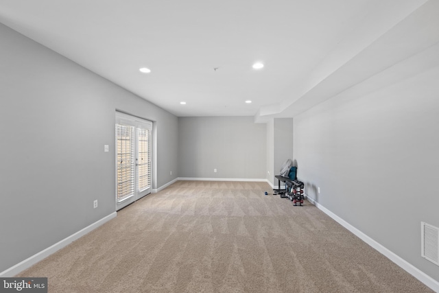 unfurnished living room featuring light carpet