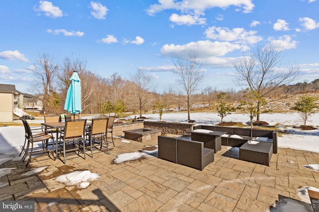 snow covered patio featuring outdoor lounge area