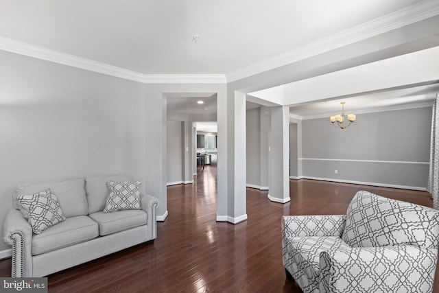 living room featuring crown molding, dark wood-type flooring, and a chandelier