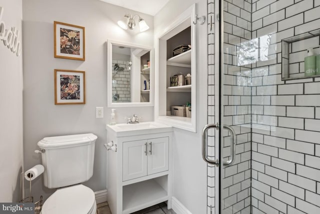 bathroom with toilet, walk in shower, vanity, and a notable chandelier