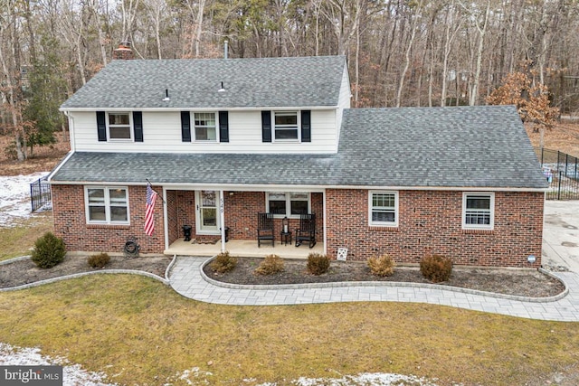 front of property with a front yard and a patio area