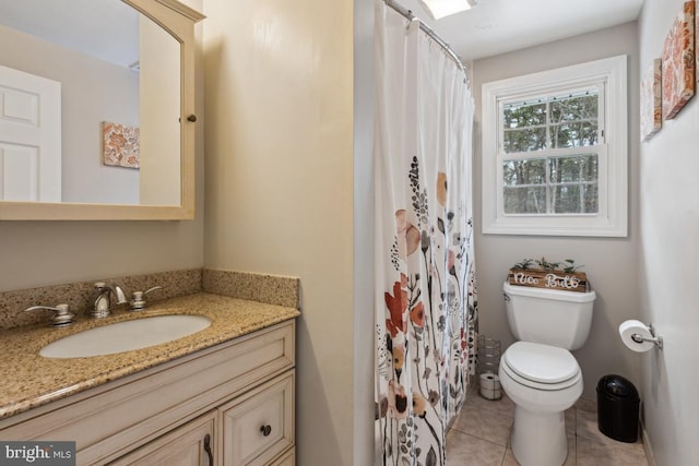 bathroom featuring toilet, tile patterned floors, and vanity