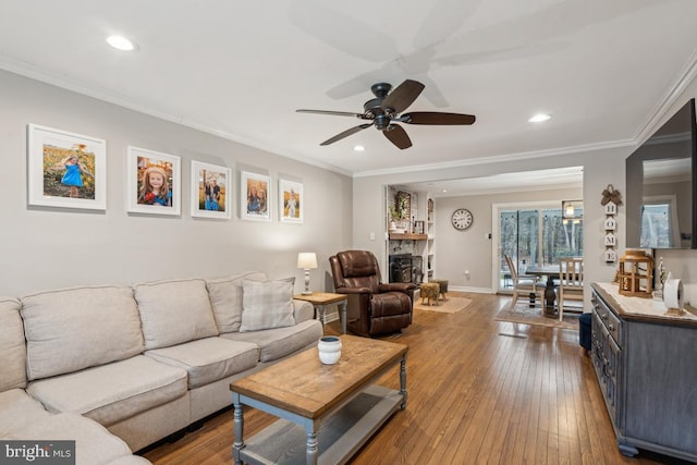 living room with ornamental molding, ceiling fan, and hardwood / wood-style floors