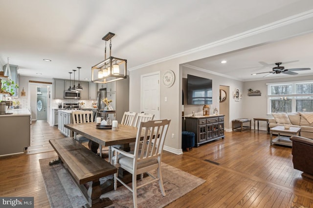 dining area with hardwood / wood-style flooring, ceiling fan, and ornamental molding