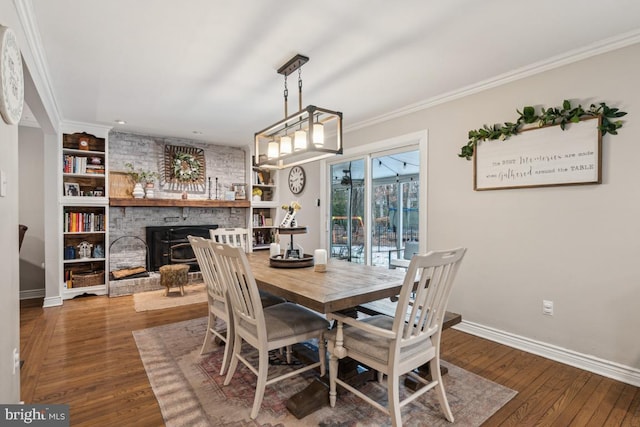 dining room featuring wood-type flooring, ornamental molding, and built in shelves