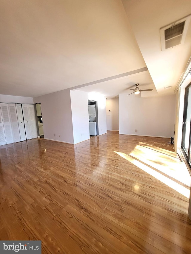 unfurnished living room with wood-type flooring and ceiling fan