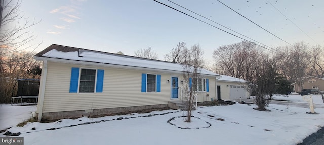 view of front facade featuring a trampoline and a garage