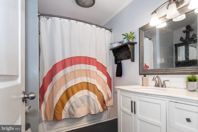 bathroom featuring walk in shower, vanity, and ornamental molding