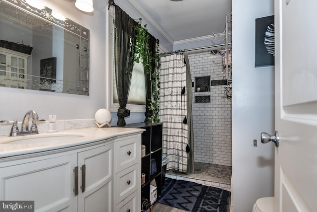 bathroom with toilet, crown molding, vanity, and curtained shower